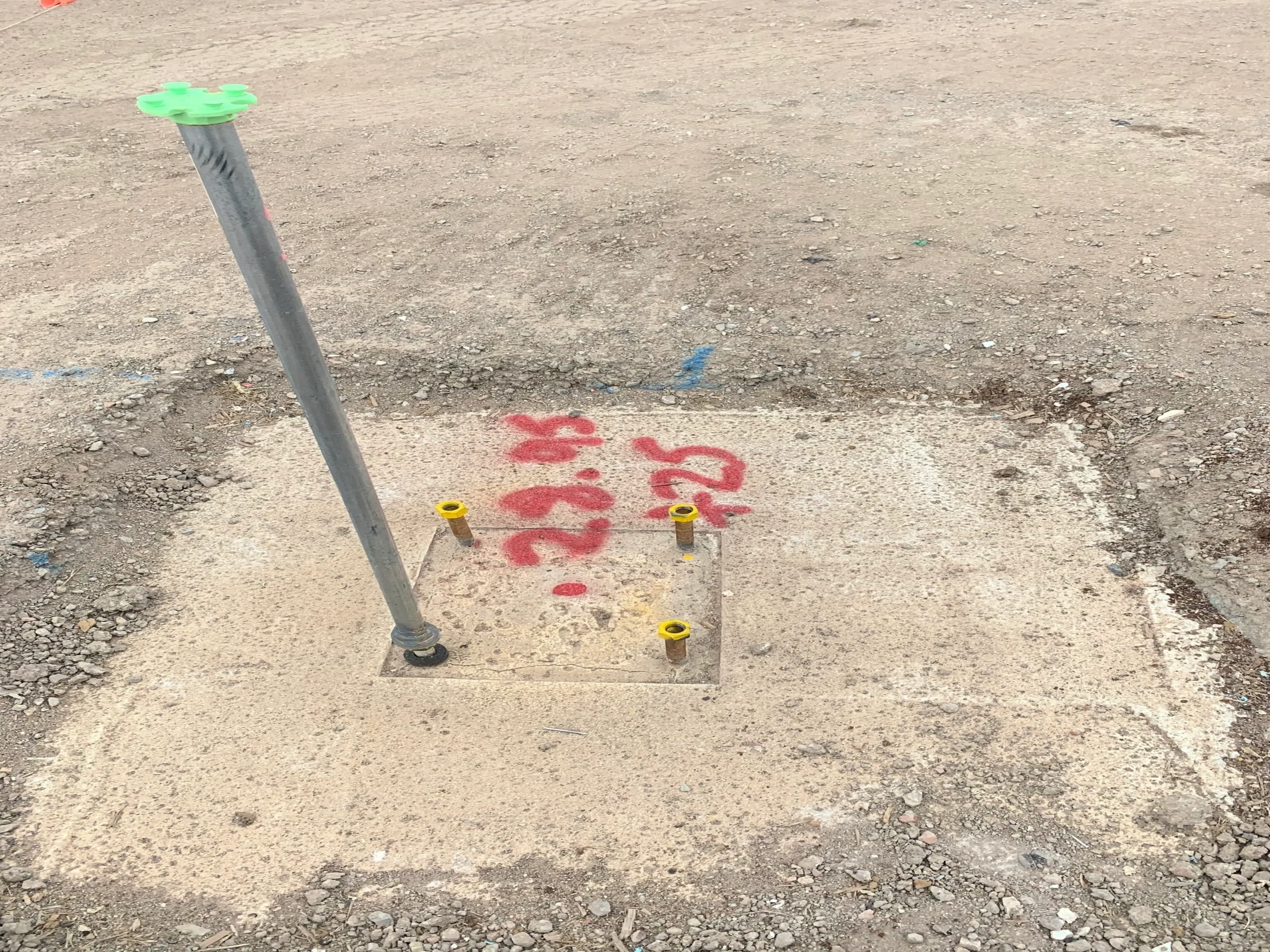 Holding-down bolts with survey markers on a construction site