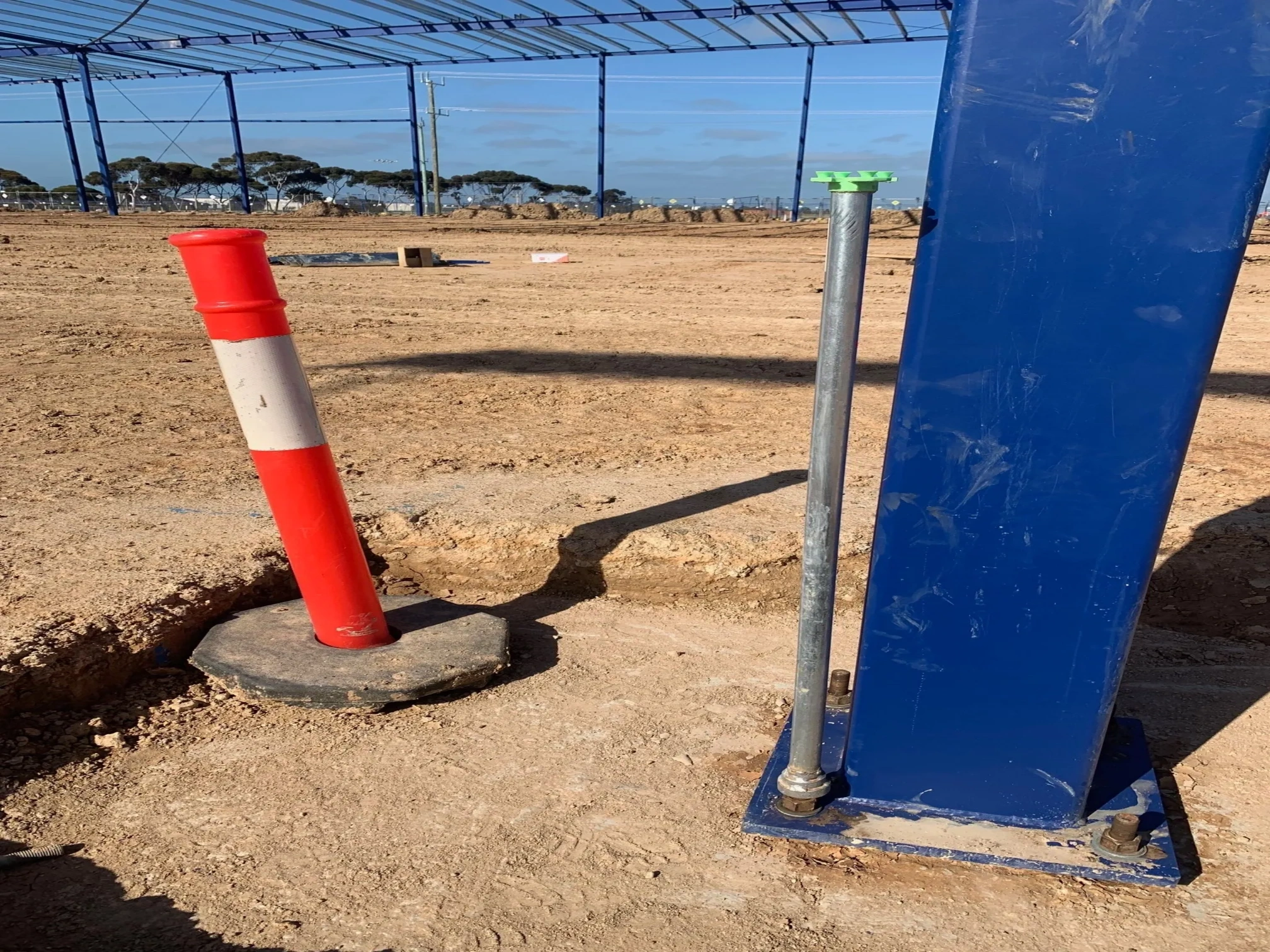 Outdoor construction site with safety bollard and industrial infrastructure